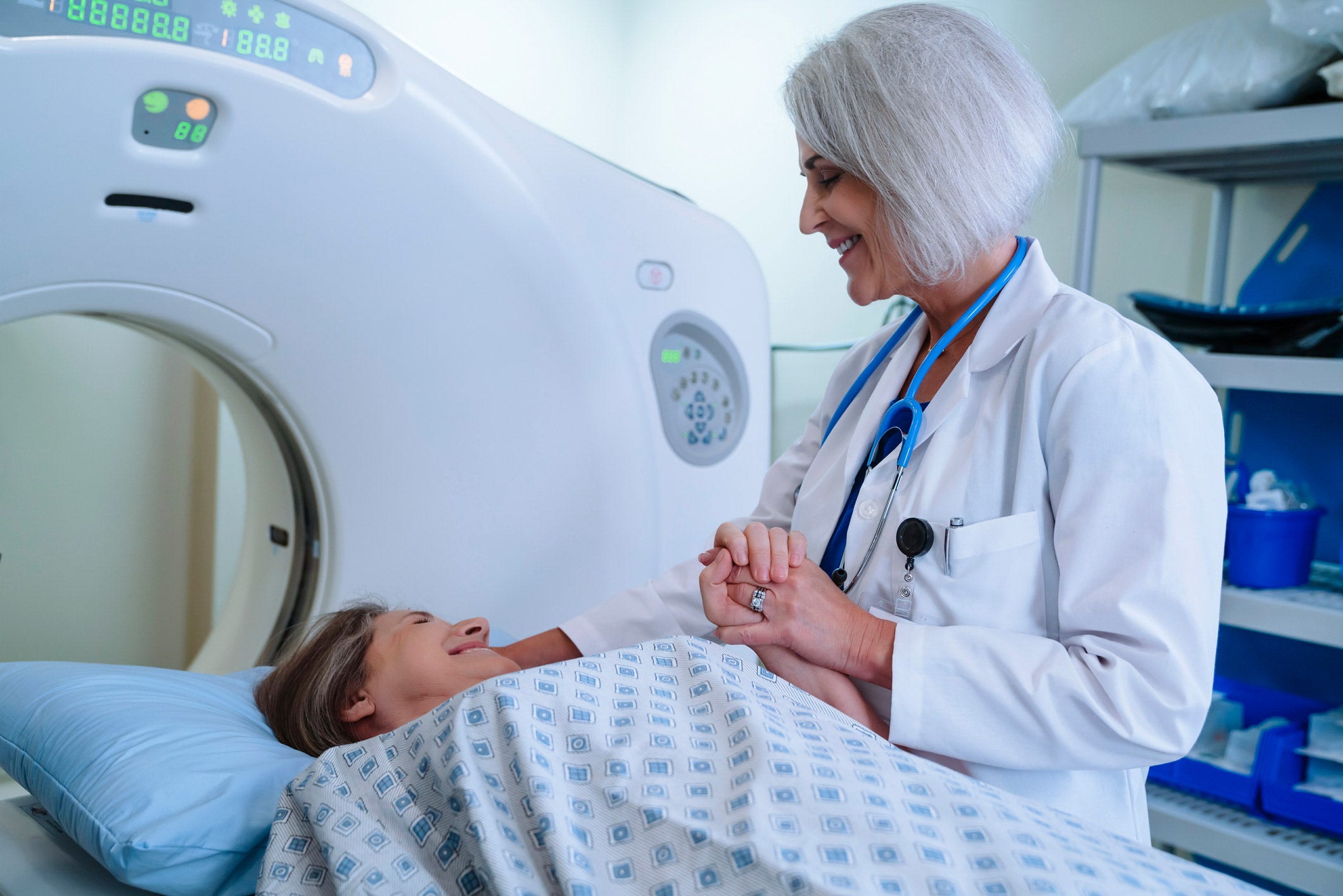 Doctor helping patient during scan