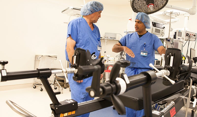 Two Doctors talking next to medical equipment