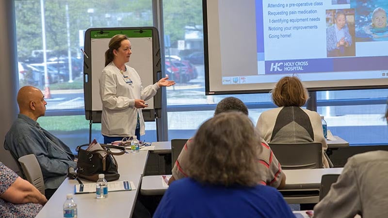 Doctor presenting to a group of people