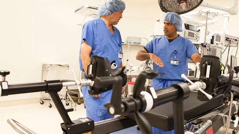 Two Doctors talking next to medical equipment