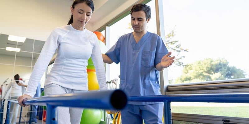 Doctor helping patient with physical therapy
